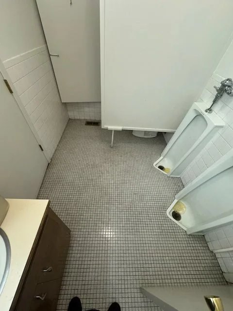 Commercial restroom tile floor with clean restored grout after professional deep cleaning